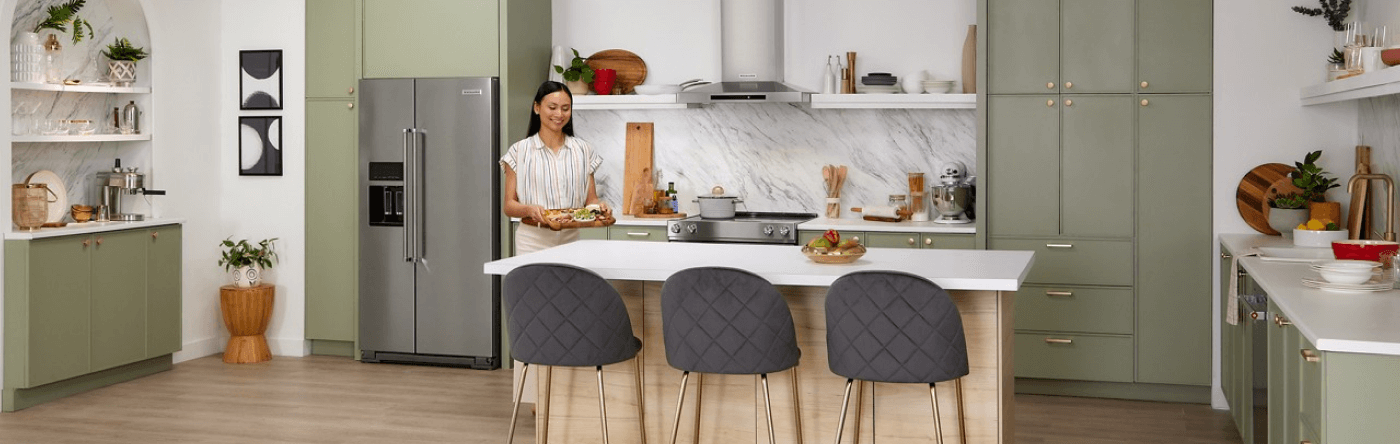 Person setting an hors d'oeuvre platter on a kitchen island