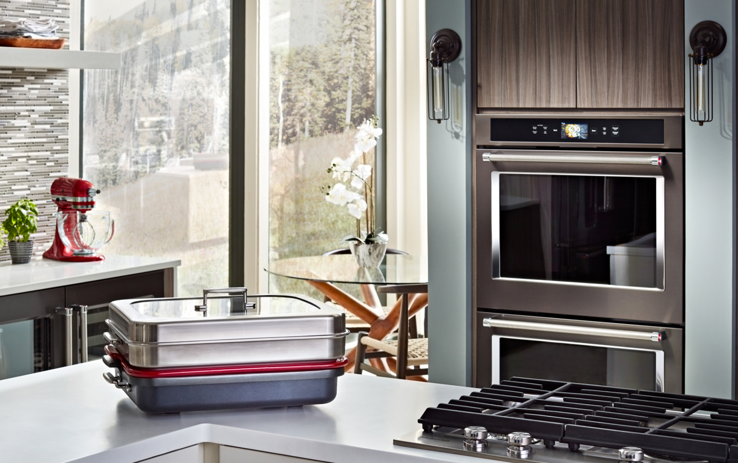 A covered baking stone in front of a double wall oven  A covered baking stone in front of a double wall oven