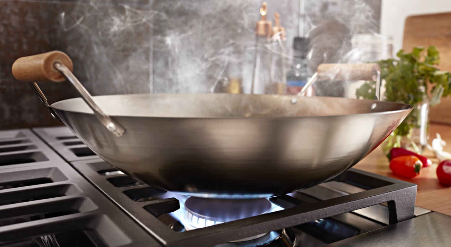 Close-up of a wok on a gas range
