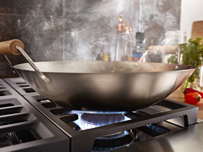 Close-up of a wok on a gas range