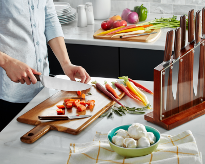 Person chopping carrots on cutting board