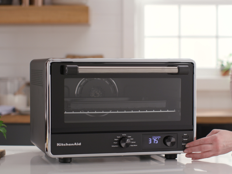 Person setting controls on a KitchenAid® countertop oven Person setting controls on a KitchenAid® countertop oven