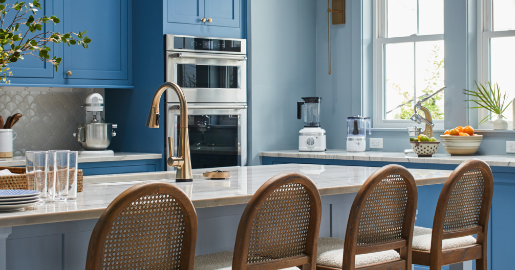 Open concept kitchen with blue walls and cabinets