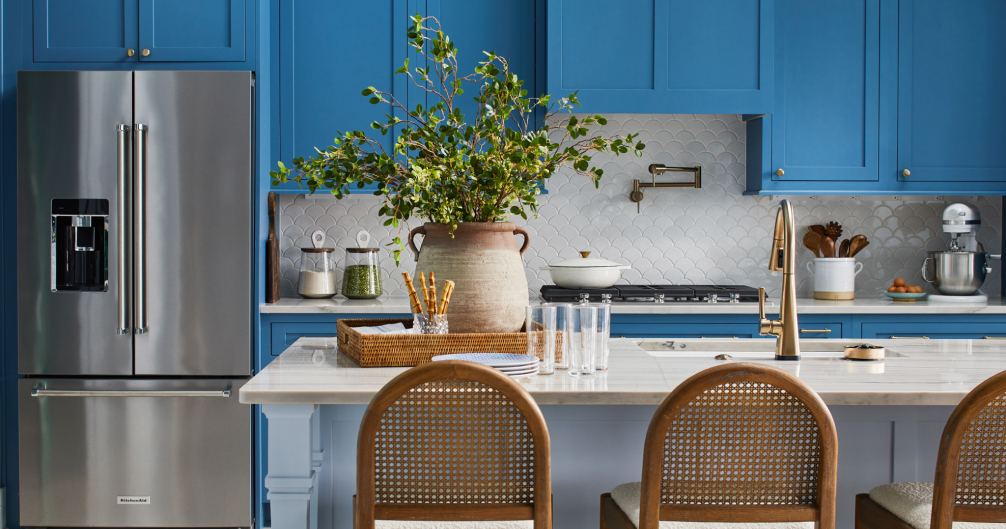 Blue kitchen with rattan kitchen island stools