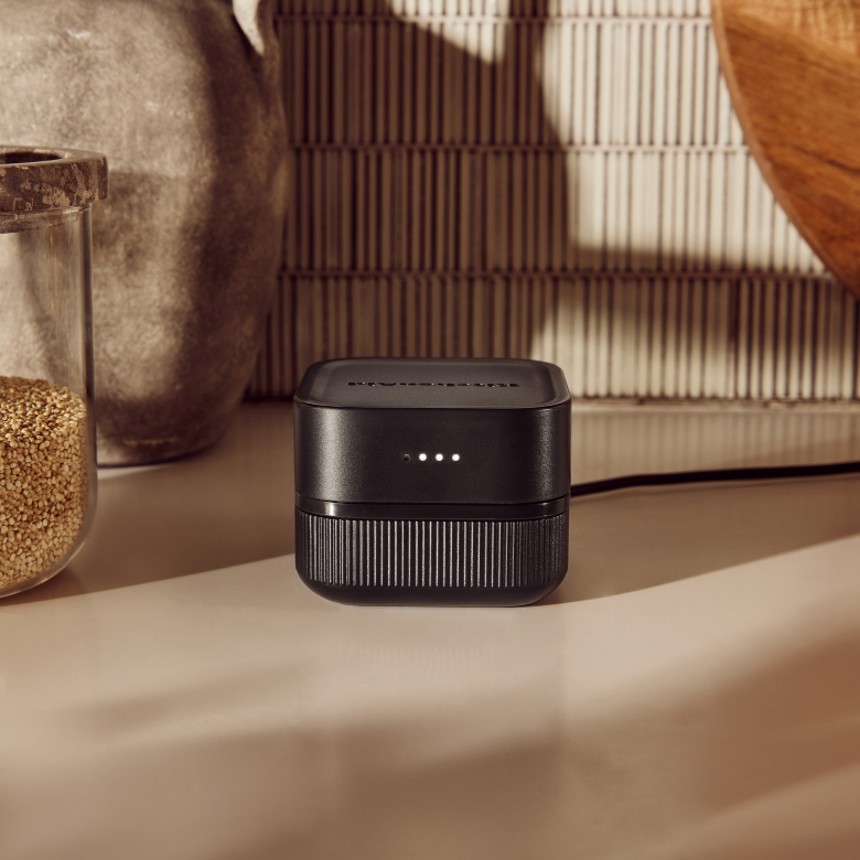 A KitchenAid Go™ Rechargable battery on its charging dock.