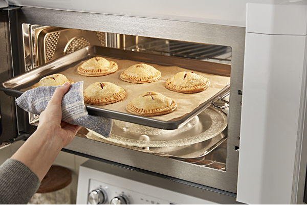 Person removing food from a microwave