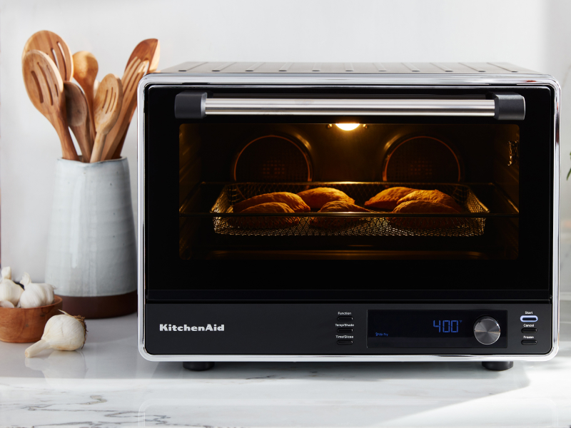 A KitchenAid® countertop oven with air fry on a modern kitchen counter.