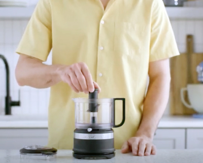 A multipurpose s-blade being attached to the food processor adaptor