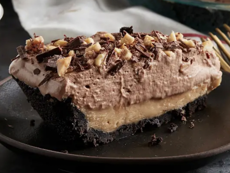 A homemade chocolate cake with nuts and chocolate shavings on top A homemade chocolate cake with nuts and chocolate shavings on top