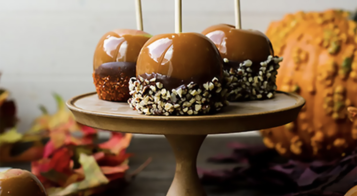 Caramel apples dipped in chocolate and chopped nuts Caramel apples dipped in chocolate and chopped nuts