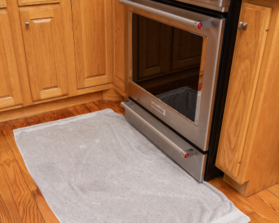 A pulled back image of oven door glass on an oven