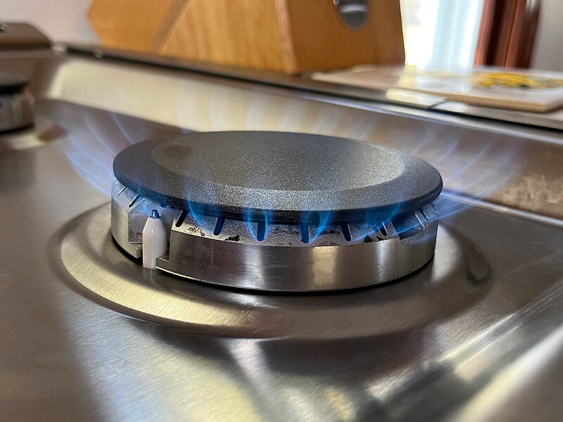 An ignited burner on a gas stove