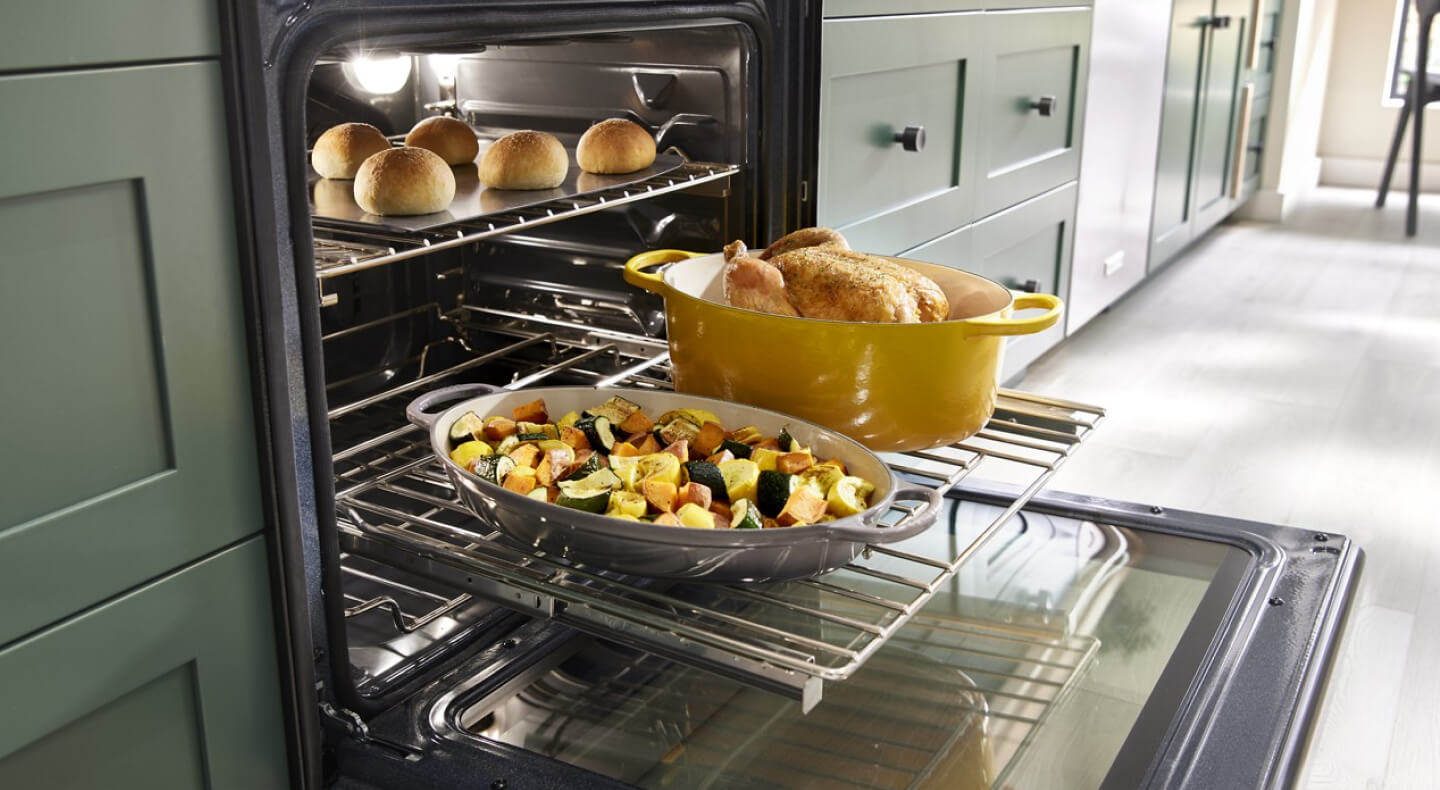 Food on an oven rack pulled out of the oven Food on an oven rack pulled out of the oven