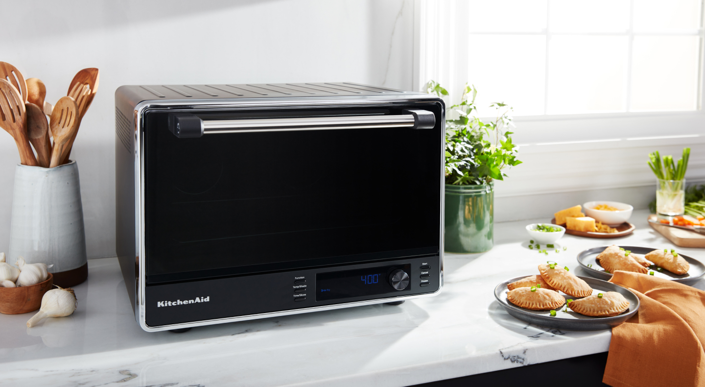 A KitchenAid® countertop oven with an air fry basket A KitchenAid® countertop oven with an air fry basket
