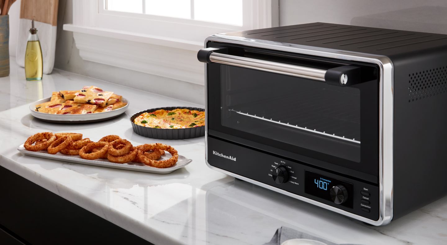 KitchenAid® countertop oven with onion rings on a tray KitchenAid® countertop oven with onion rings on a tray