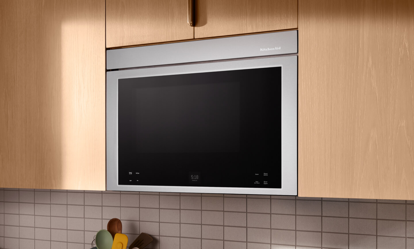 Flush over-the-range microwave built into wooden cabinets
