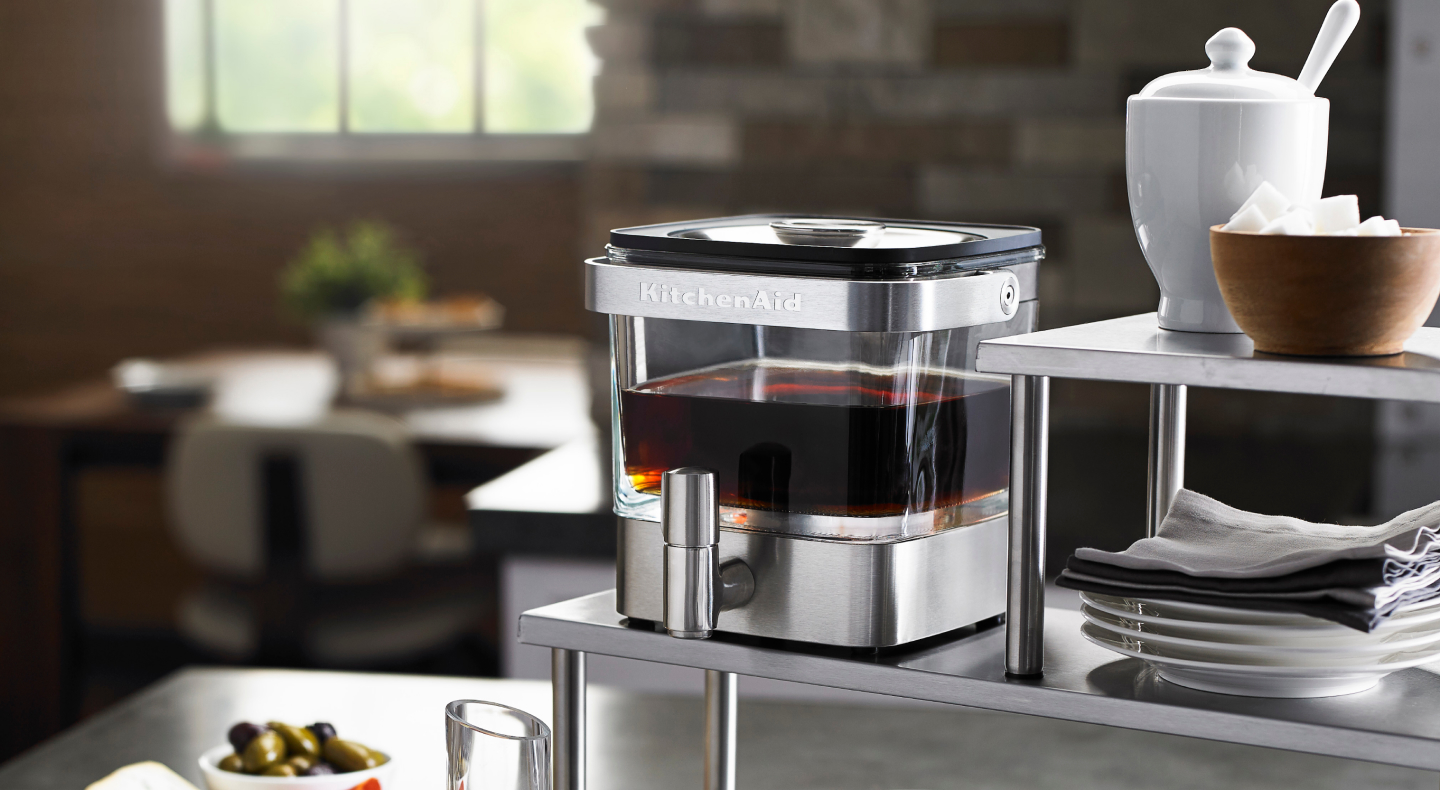 Full cold brew coffee maker near bowl of sugar cubes Full cold brew coffee maker near bowl of sugar cubes