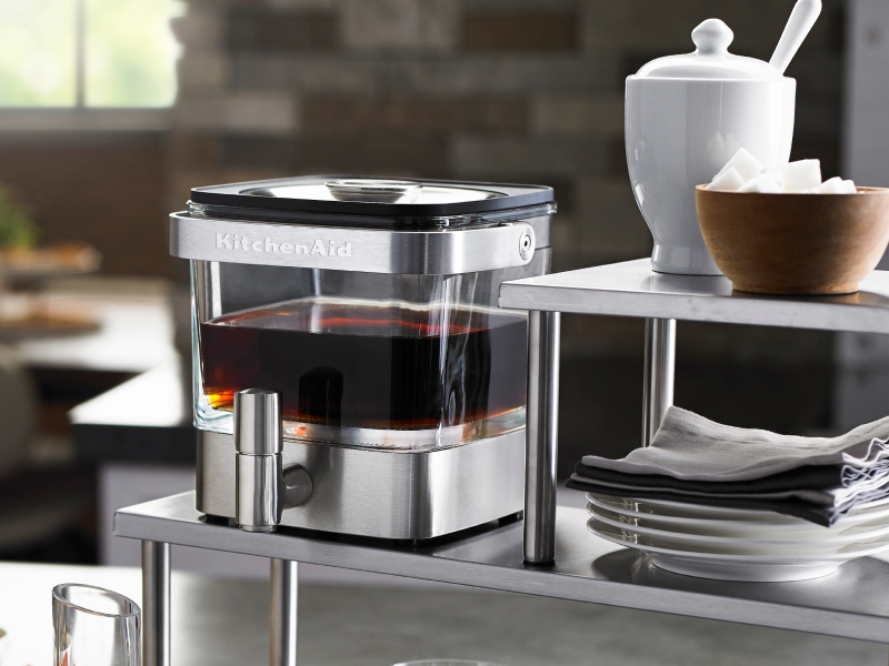 Full cold brew coffee maker near bowl of sugar cubes Full cold brew coffee maker near bowl of sugar cubes