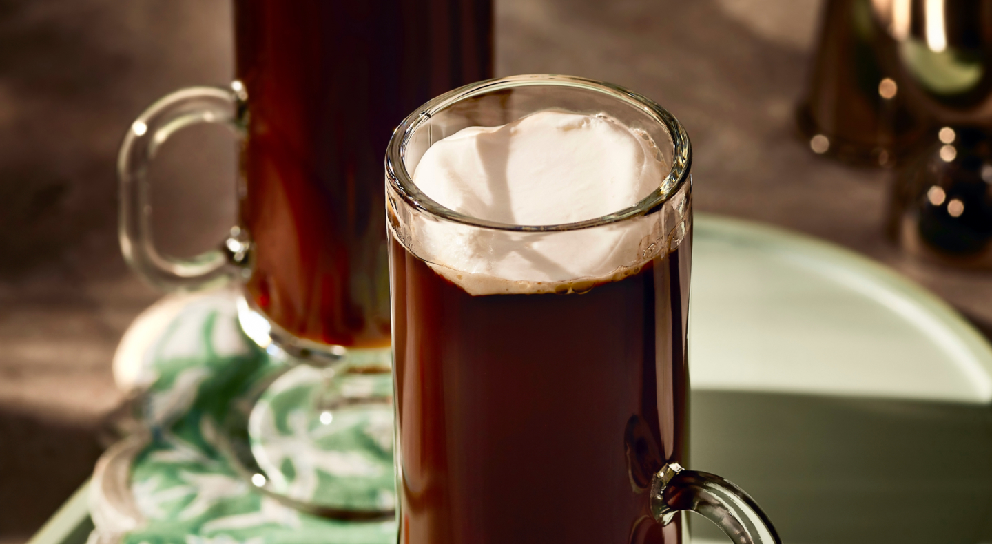 An espresso drink with a dollop of whipped cream.