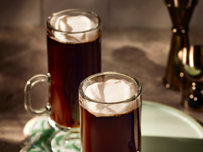 An espresso drink with a dollop of whipped cream. An espresso drink with a dollop of whipped cream.