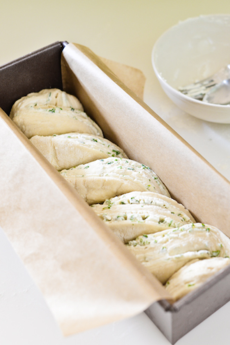 Braided babka resting in a prepared loaf pan