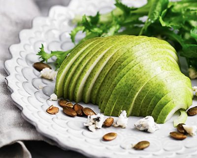 A platter of spiralized fruit and leafy greens.