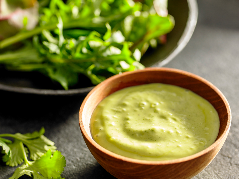 A dish of avocado cilantro dressing. A dish of avocado cilantro dressing.