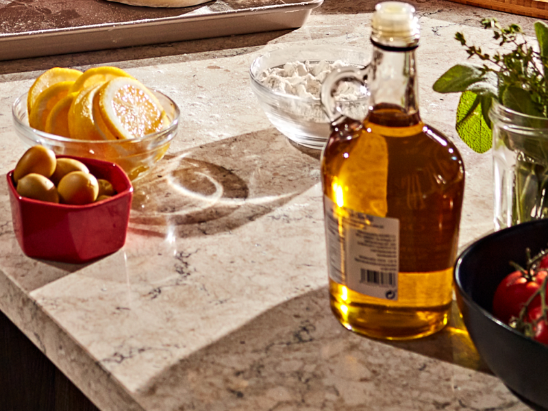 Sliced lemons, cherry tomatoes, herbs and a jar of vinaigrette. Sliced lemons, cherry tomatoes, herbs and a jar of vinaigrette.