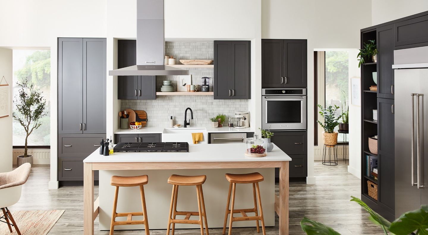 Kitchen with gray cabinets and island with cooktop Kitchen with gray cabinets and island with cooktop