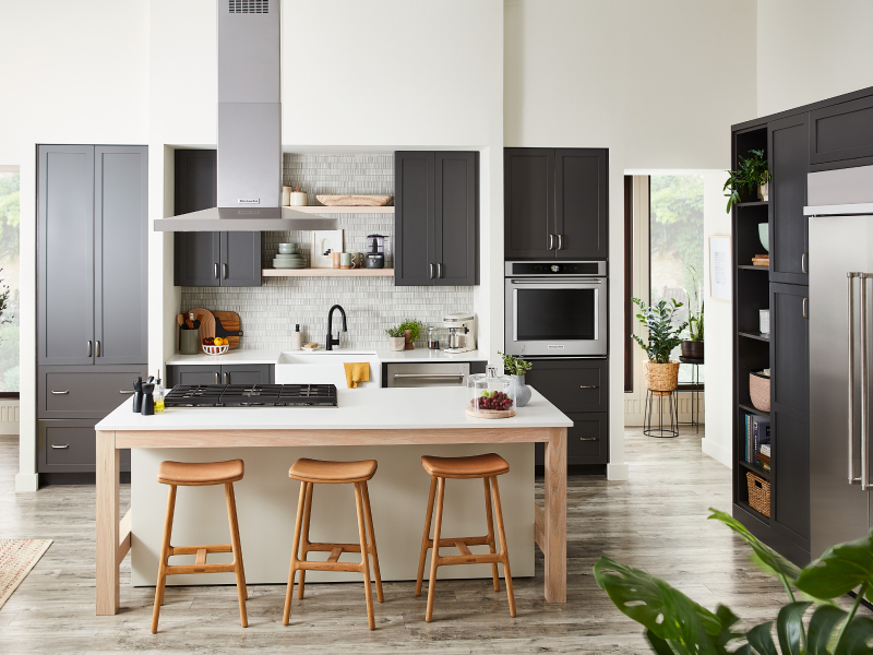 Kitchen with gray cabinets and island with cooktop Kitchen with gray cabinets and island with cooktop