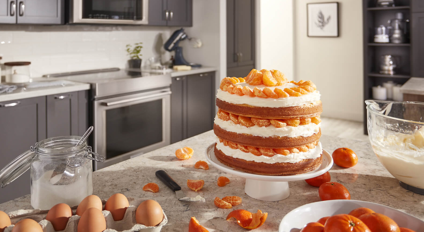 Three layer orange cake on a counter Three layer orange cake on a counter