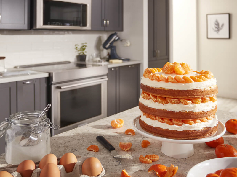 Three layer orange cake on a counter Three layer orange cake on a counter