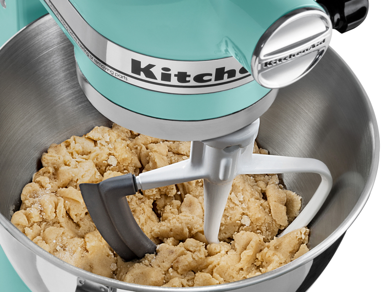 A teal KitchenAid® stand mixer with Flat Beater Attachment used to mix cookie dough