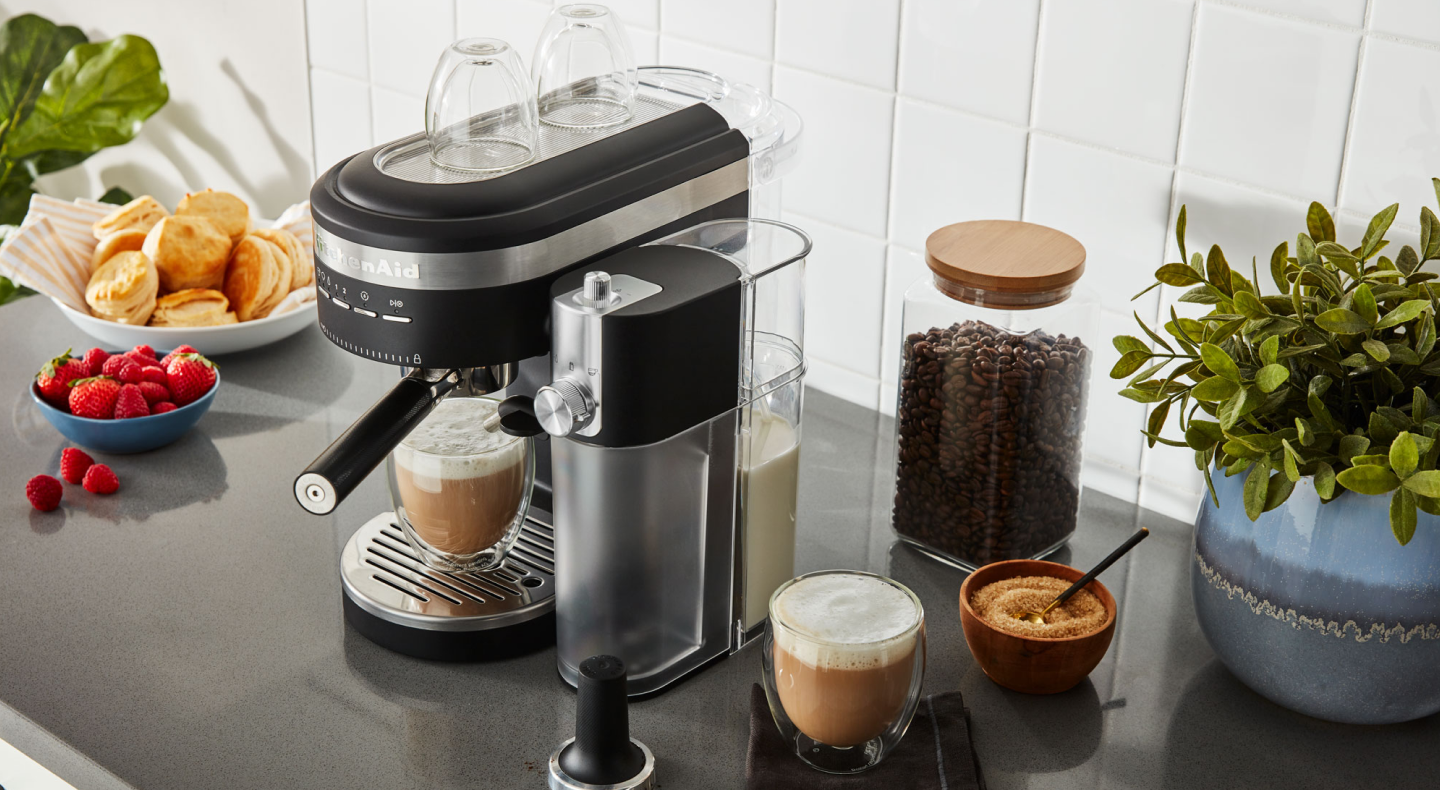 Espresso machine and milk frother on countertop with café style drinks Espresso machine and milk frother on countertop with café style drinks