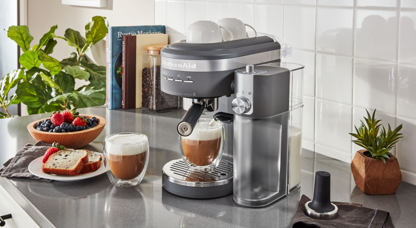 Espresso machine and lattes on countertop with breakfast items Espresso machine and lattes on countertop with breakfast items