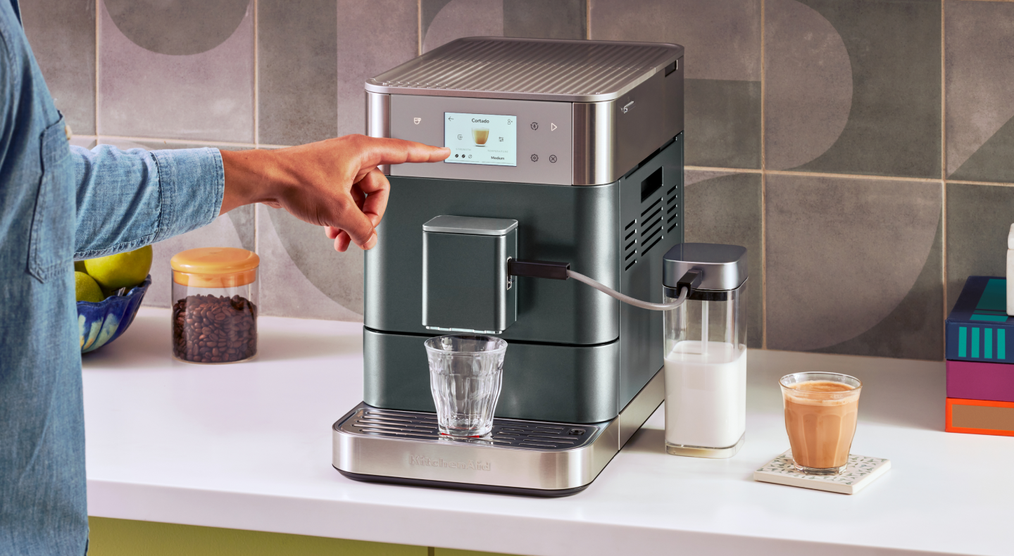 Person making an espresso beverage with a KitchenAid® Fully Automatic Espresso Machine