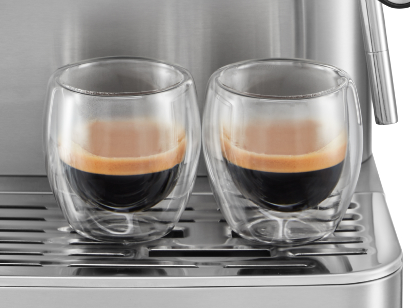 Two ristretto shots resting on the base of an espresso machine