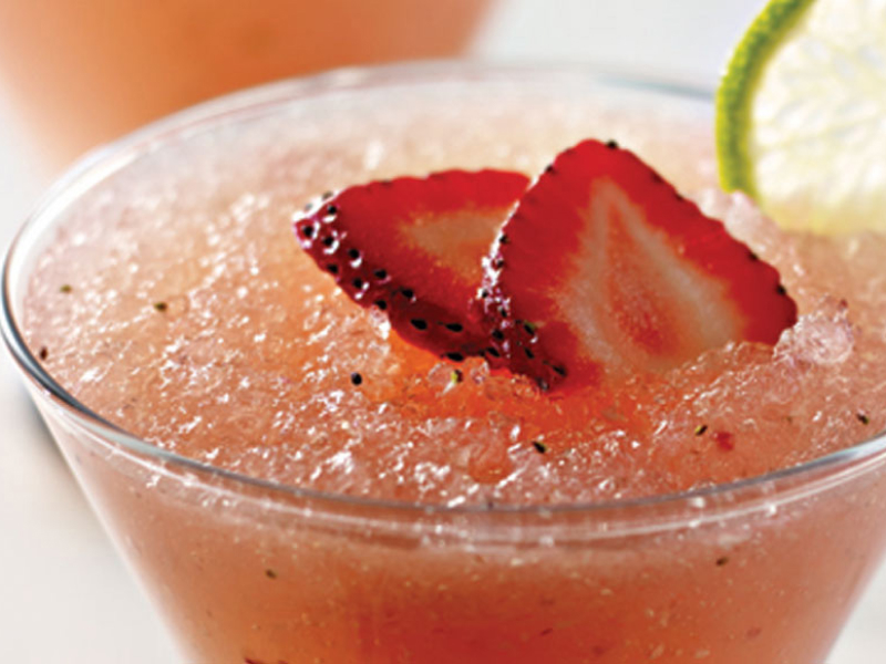 Frozen pink lemonade with strawberry garnish