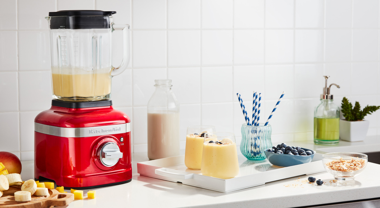 KitchenAid® blender next to tray with frozen fruit drinks KitchenAid® blender next to tray with frozen fruit drinks