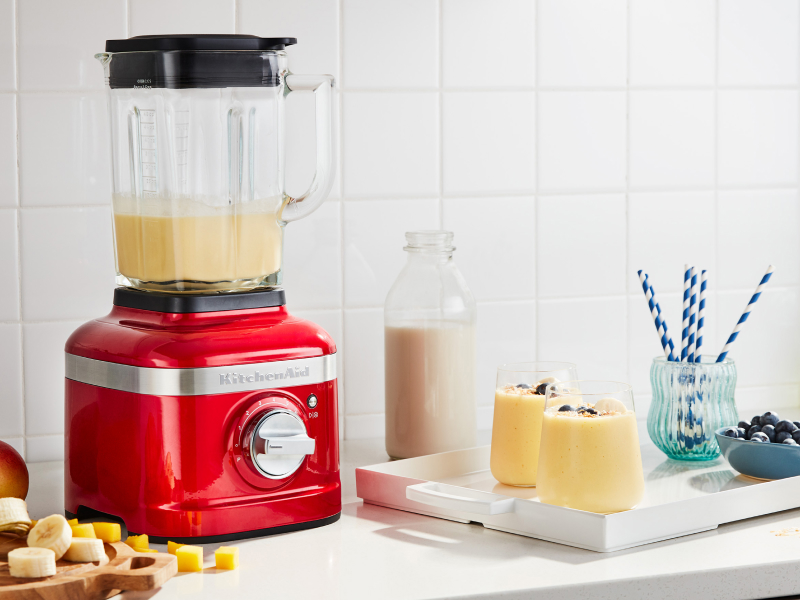 KitchenAid® blender next to tray with frozen fruit drinks KitchenAid® blender next to tray with frozen fruit drinks