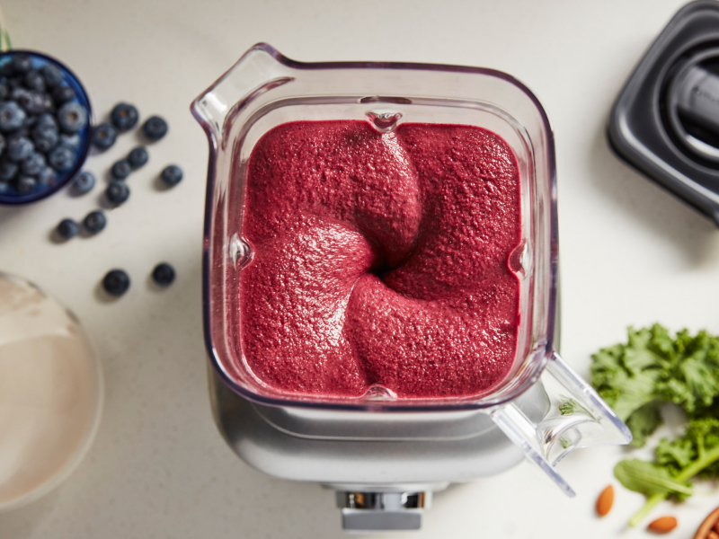 A red purée mixture in a blender.