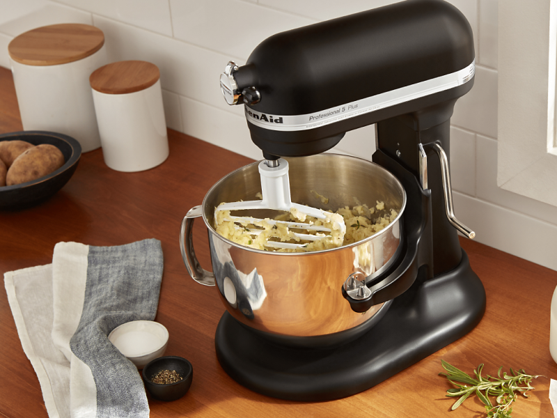 A KitchenAid® stand mixer mashing potatoes.