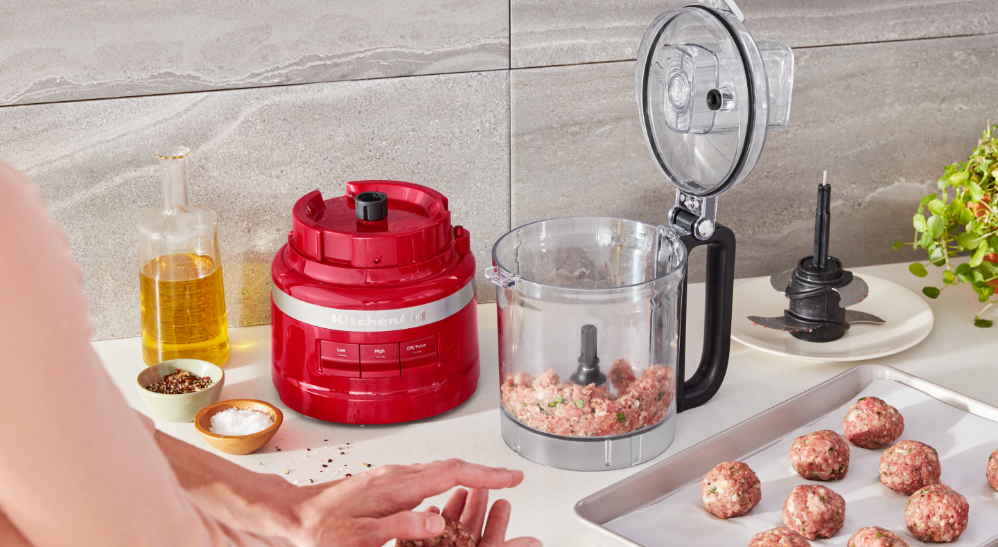 Ground beef inside a red KitchenAid® food processor Ground beef inside a red KitchenAid® food processor
