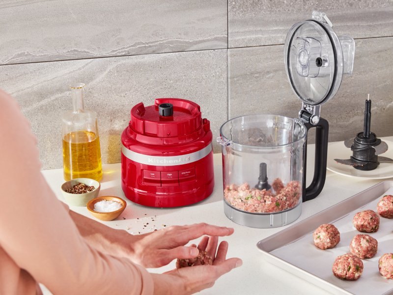Ground beef inside a red KitchenAid® food processor Ground beef inside a red KitchenAid® food processor