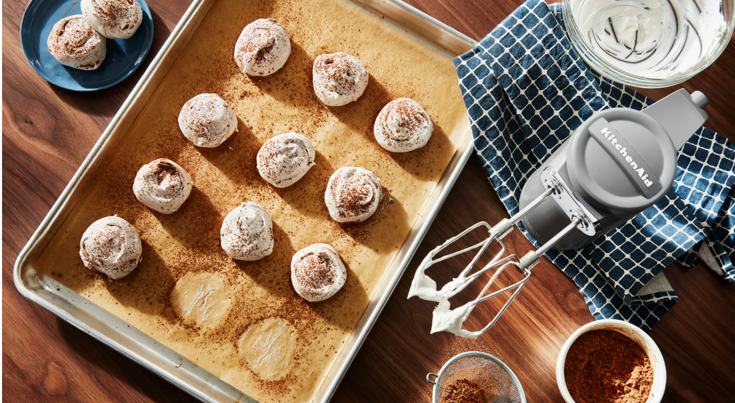 KitchenAid® hand mixer and meringue on a cookie sheet KitchenAid® hand mixer and meringue on a cookie sheet