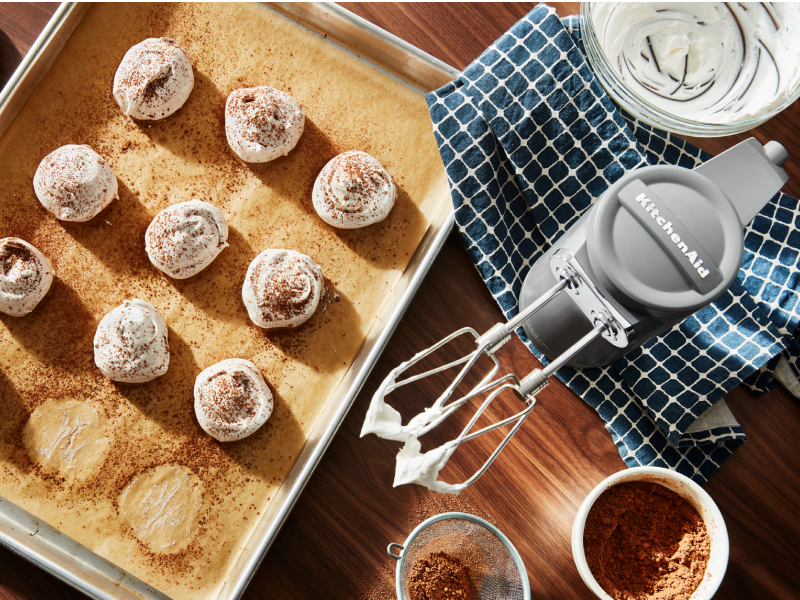 KitchenAid® hand mixer and meringue on a cookie sheet KitchenAid® hand mixer and meringue on a cookie sheet