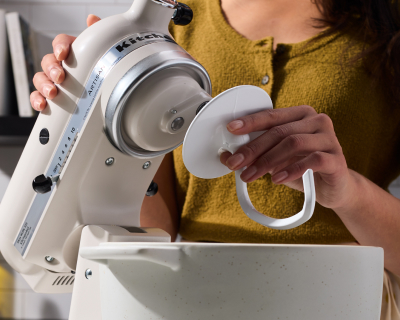 Maker affixing Dough Hook Accessory to KitchenAid® stand mixer