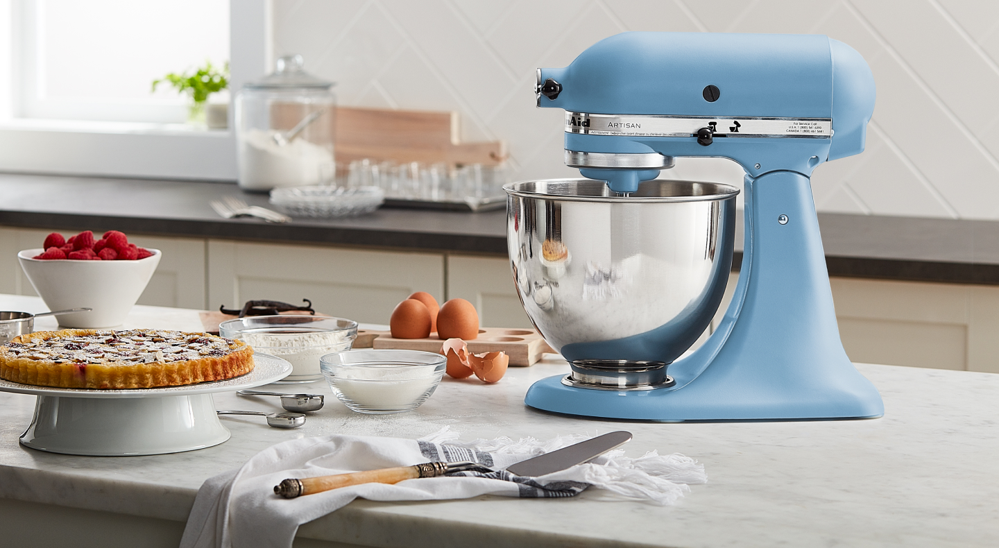 A light blue KitchenAid® stand mixer next to various ingredients A light blue KitchenAid® stand mixer next to various ingredients