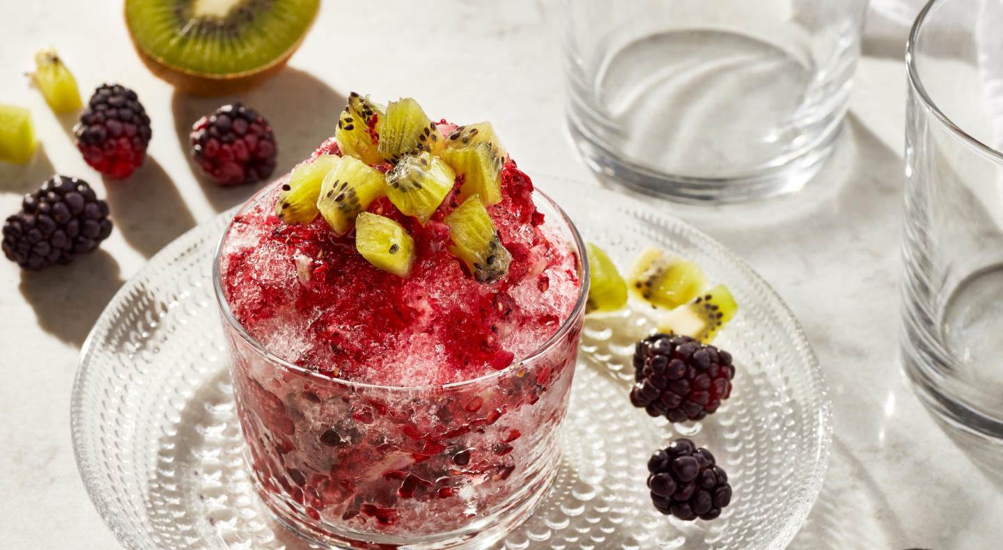 Shaved ice dessert topped with chopped fruit  Shaved ice dessert topped with chopped fruit