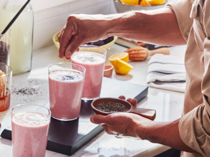 Person sprinkling seeds on a shake